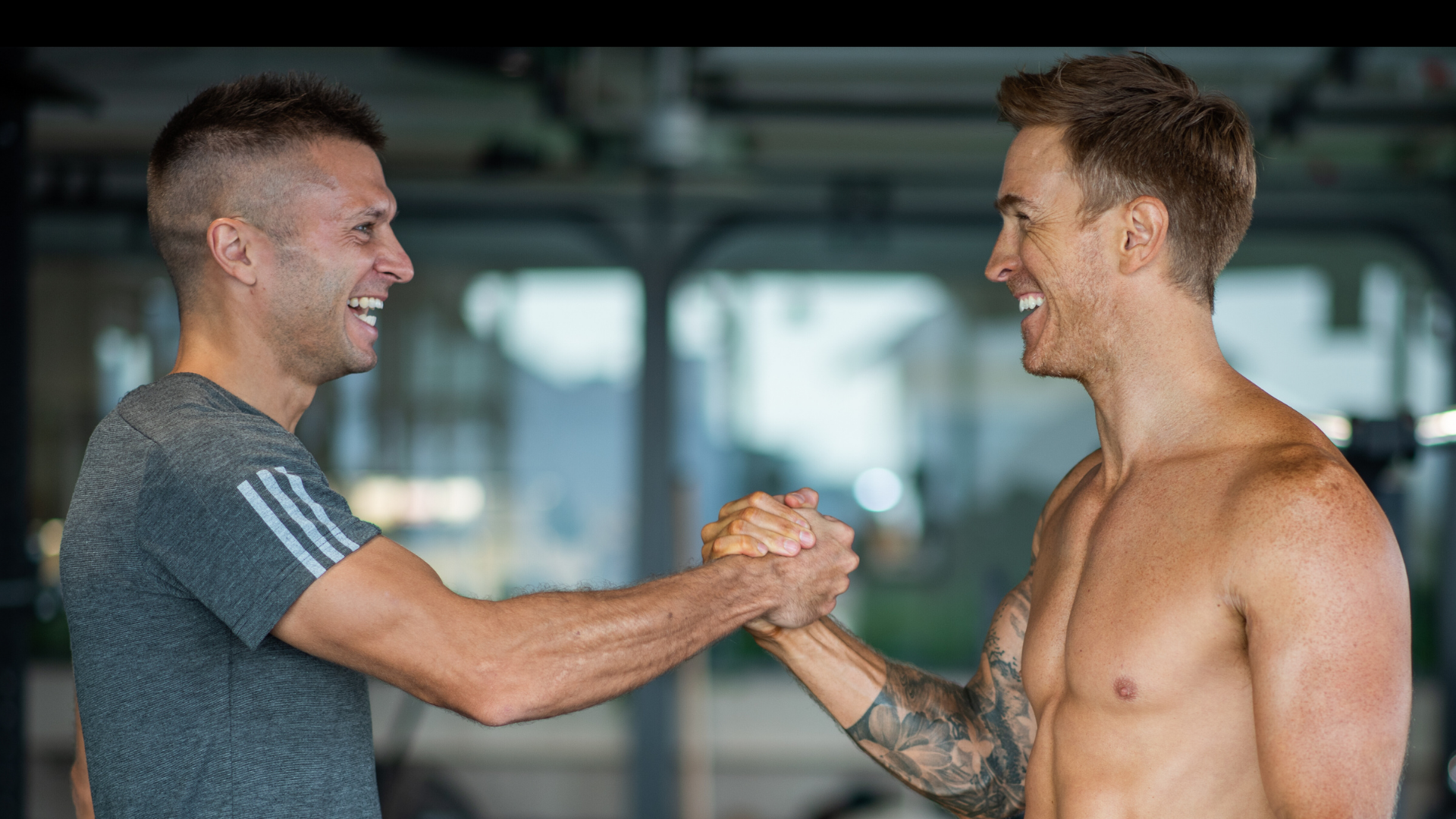 Tom Hine celebrating success with a transformed client in professional gym setting